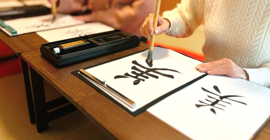 Osaka: Private Japanese Calligraphy Experience - Colored paper, the initial stamp, and the finished look